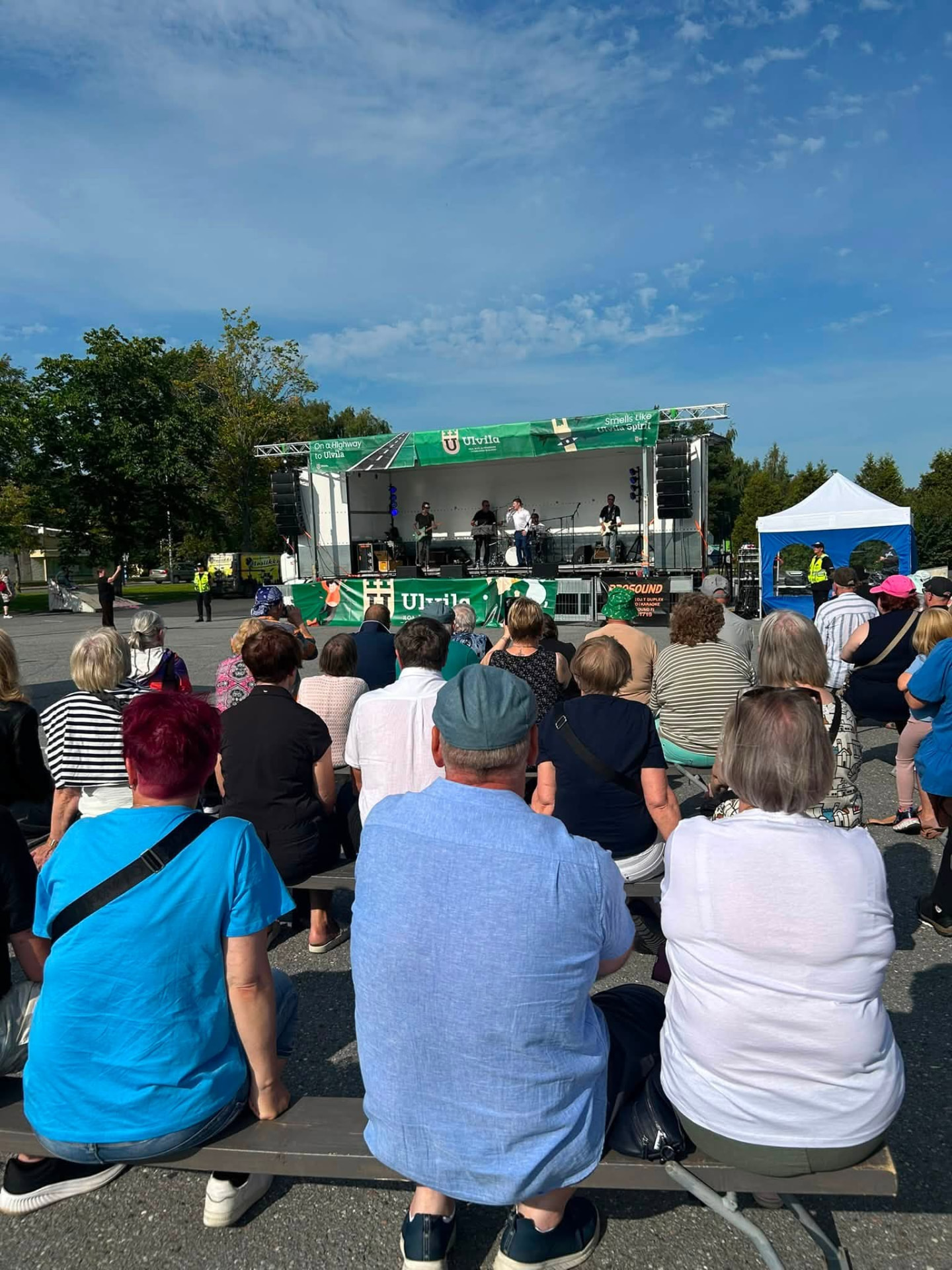 Live band performing on the Ulvila summer event stage with a seated audience