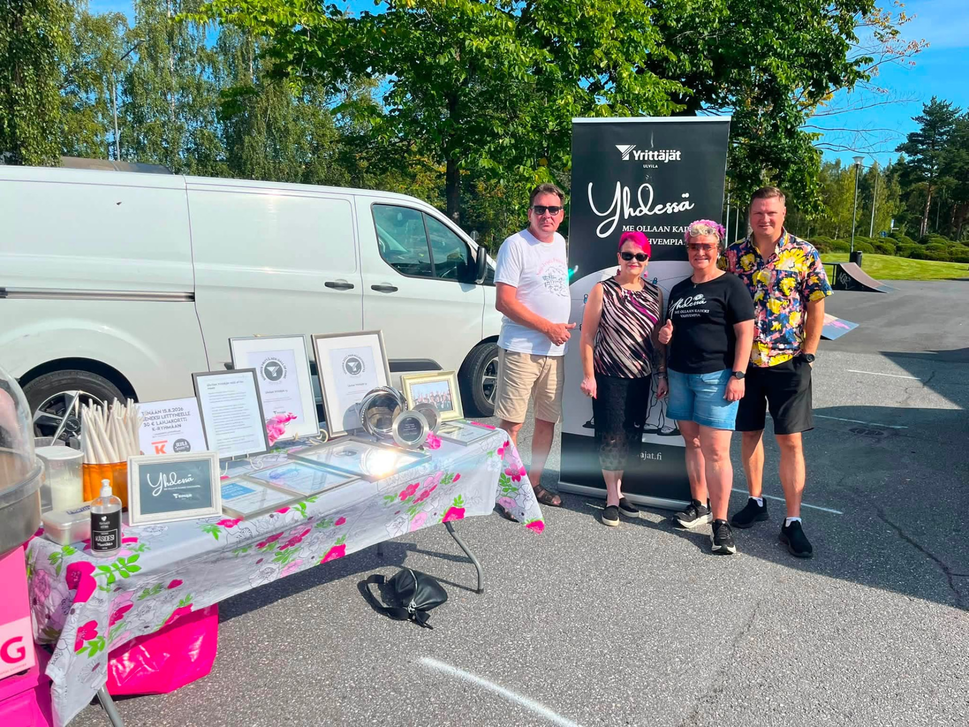 Volunteers and partners standing together beside the association's event stand